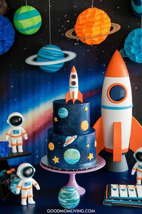 Colorful space-themed birthday cake featuring planets and stars, with a rocket topper, surrounded by astronaut figurines and decorative planets on a vibrant cosmic backdrop. Ideal for a children's space party. Planets Birthday Party Ideas, Astronaut Birthday Theme, Space Theme Party Decorations, Solar System Birthday, Space Birthday Party Ideas, Space Party Food, Outer Space Party Decorations, Planet Birthday, Space Party Decorations