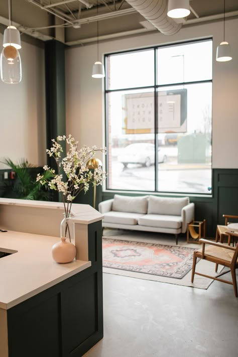 Dental office waiting room in Nashville, TN. #concrete floors #open ceiling #wainscoting #modern #green walls #living room ideas #layered rugs #midcentury Mid Century Waiting Room, Modern Farmhouse Waiting Room, Boho Commercial Office, Medspa Design Waiting Area, Cute Waiting Room Ideas, Colorful Dental Office, Welcoming Waiting Room, Dr Office Waiting Room, Boutique Medical Office