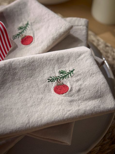 Crafted from cotton, our embroidered bauble napkins are the perfect combination of Christmas décor with a subdued and minimalist feeling.        With a simple embroidered bauble on the right hand side, the neutral background complements the minimal design creating a napkin that will blend into any dining setting seamlessly.       A matching table runner is also available.        Explore the rest of our Regency Romance collection.