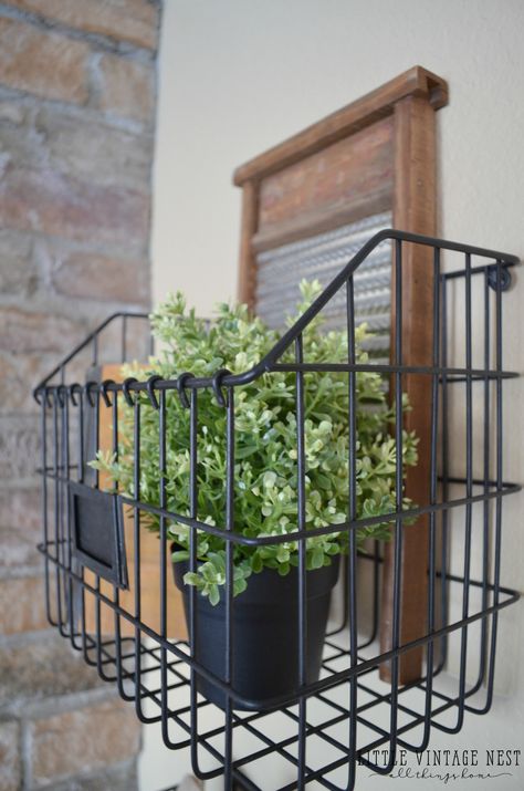 Farmhouse Style: Decorating with Wire Baskets Wire Basket Under Bench, Wall Wire Basket Decor, Wire Basket Wall Decor Ideas, Wire Baskets On Wall, Decorating With Wire Baskets, Basket Hanging On Wall, Wall Basket Decor Farmhouse, Wire Basket Decor Ideas, Wire Basket Decor