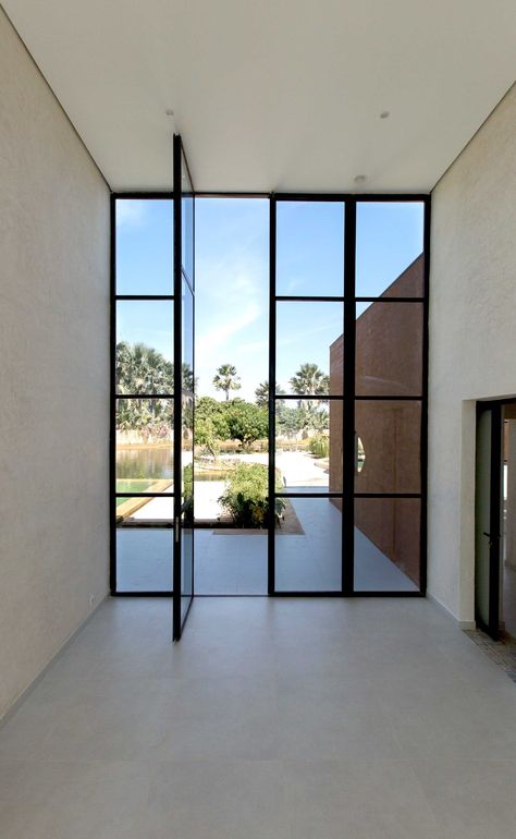 Image 14 of 27 from gallery of "Khamsa" House / Atelier Koe. Photograph by Régis L'hostis French Double Doors, Steel Doors And Windows, Metal Front Door, Steel Front Door, Glass Doors Interior, Glass Front Door, Entrance Doors, Patio Doors, Semarang