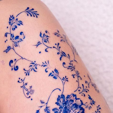 Oozy on Instagram: "Flowers in the thigh ❄️ . Done at @greystudiola . #oozy #oozytattoo #tattoo #kwadron" Oozy Tattoo Style, Blue Porcelain Tattoos, Korean Flowers Tattoo, China Plate Tattoo, Blue China Tattoo White Porcelain, Blue Ink Flower Tattoo, Blue Ornamental Tattoo, Rosemailing Flowers Tattoo, Blue China Patterns Tattoo