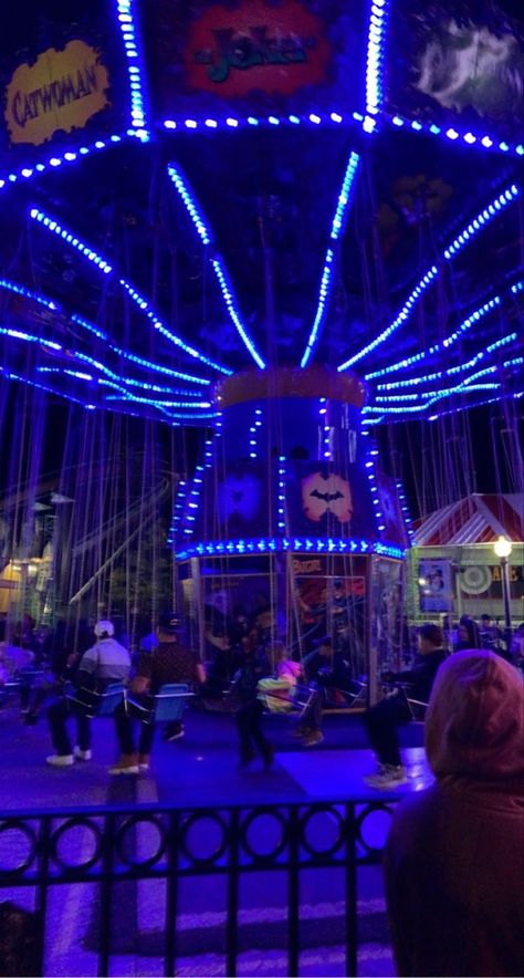 Theme park ride at night with glowing neon blue lights Park At Night Aesthetic, Aesthetic Theme Park, Aesthetic At Night, Bike Ride Aesthetic, Ride Aesthetic, At Night Aesthetic, Neon Carnival, Carnival Date, Park At Night