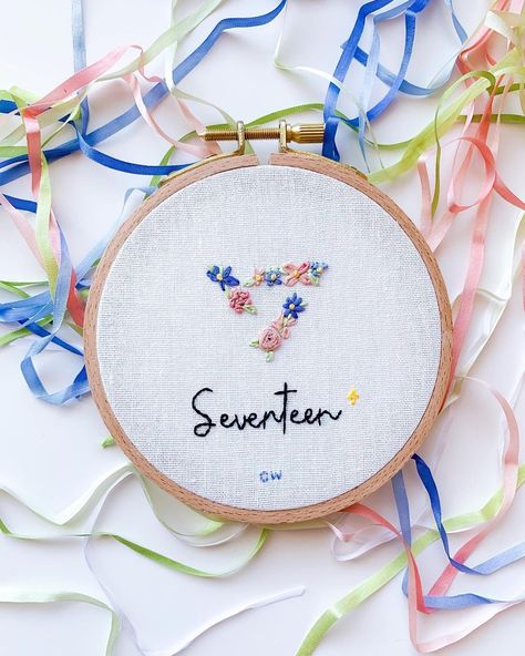 Clara on Instagram: “Seventeen’s 7th Anniversary 💖 Last year, I embroidered a shirt for SVT’s 6th anniversary so this year I wanted to create a hoop piece with…” Seventeen Embroidery Kpop, Seventeen Gift Ideas, Seventeen Diy Ideas, Txt Embroidery, Seventeen Embroidery, Bridgerton Embroidery, Seventeen Crochet, Seventeen Design, Seventeen Drawing