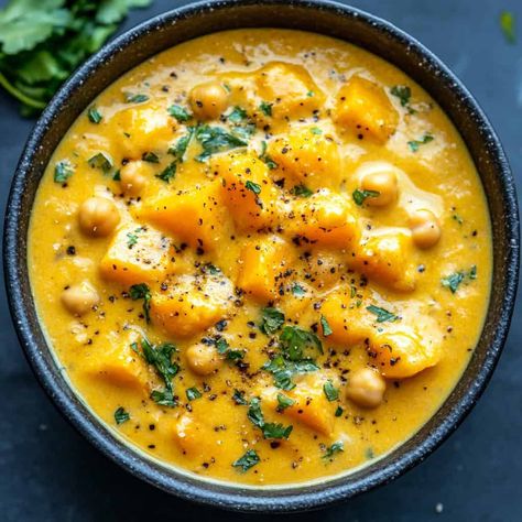 A bowl of creamy butternut squash curry with chickpeas, garnished with cilantro and black pepper. Butternut Squash And Chickpea Curry, Curry With Chickpeas, Butternut Squash Muffins, Butternut Squash Gratin, Butternut Squash Pizza, Squash Curry, Butternut Squash Curry, Healthy Butternut Squash, Creamy Butternut Squash