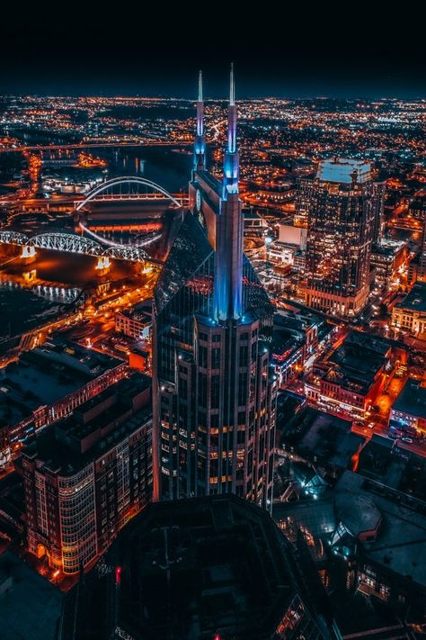 Aerial skyline at night with lots of blue and orange lights highlighting the city and buildings. Country Music Playlist, Road Trip Gifts, Nashville City, Nashville Skyline, Trivia Facts, Nashville Trip, Urban Aesthetic, Grand Ole Opry, About Music