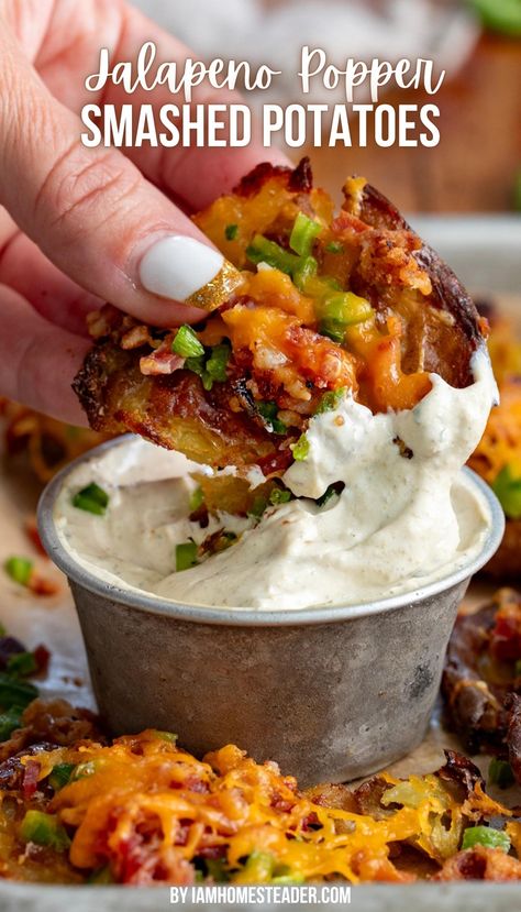 A hand is holding a smashed potato and dipping it into a creamy sauce in a silver cup. There are other smashed potatoes around it on parchment paper. Jalapeño Mashed Potatoes, Get Together Side Dishes, Jalapeño Popper Smashed Potatoes, Side Dish For Friendsgiving, Food Truck Potatoes, Football Season Dinners, Jalapeno Popper Baked Potato, Jalapeno Popper Potatoes, Potatoes And Jalapenos