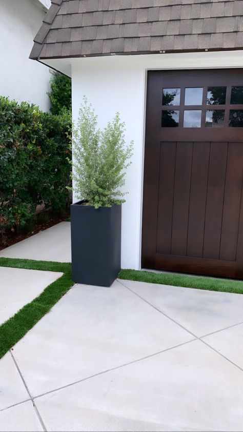 New irrigated planter and walnut garage door coffee stain Planters Outside Garage, Plants By Garage Door, Planter By Garage Door, Potted Plants By Garage Doors, Entry Way Planter Ideas, Garage Door Flower Planters, Potted Plants In Front Of Garage, Garage Outdoor Decor, Planters Between Garage Doors