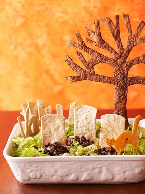 Cut tortillas in eerie shapes to make this spooky Graveyard Dip. Recipe: http://www.bhg.com/recipe/poultry/tombstone-taco-dip/?socsrc=bhgpin100812tombstonetacodip Quick Halloween Party Food, Snack Halloween, Halloween Party Appetizers, Halloween Party Treats, Halloween Party Snacks, Taco Dip, Halloween Appetizers, Halloween Goodies, Snacks Für Party