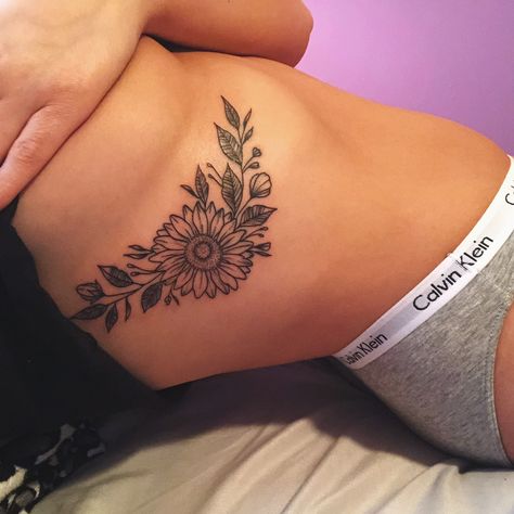 Womens Sunflower Tattoo, Cover Up Tattoos Underboob, Sunflower Spine Tattoos For Women, Sunflower Hip Tattoos Women, Sunflower Hip Tattoo, Sunflower Sternum Tattoo, Underboob Tattoo Flower, Sunflower Rib Tattoo, Sunflower Spine Tattoo