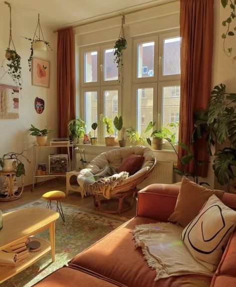 Cottagecore Apartment Decor Cozy, Green And Orange Boho Living Room, Modern Earthy Apartment, Modern Boho Chic Living Room Retro, Boho Living Room Design Ideas, Plant Filled Studio Apartment, Papasan Chair Living Room Ideas, Vintage London Apartment, Coffee Table Cozy