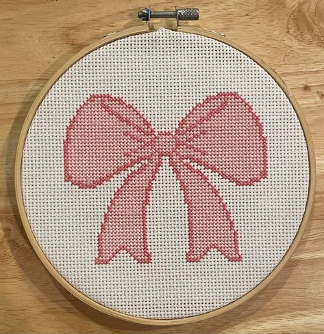 Create your own pretty pink bow! This cross stitch pattern is simple and fun! Step-by-step cross stitch directions are included, so this pattern is perfect for beginners but can also be done by advanced cross stitchers! Downloadable pattern includes a color chart and a black and white chart as well as a page of directions and an information page specific to this pattern. The finished pattern is 4.25" x 3.5" if done on 14 count cross stitch fabric. A full kit is available for purchase in my shop! Cross Stitch Patterns Aesthetic, Aesthetic Cross Stitch, Pink Cross Stitch, Christmas Cross Stitch Patterns Free, Crochet Grid, Needlepoint Stockings, Needlepoint Designs, Beaded Cross Stitch, Needlepoint Patterns