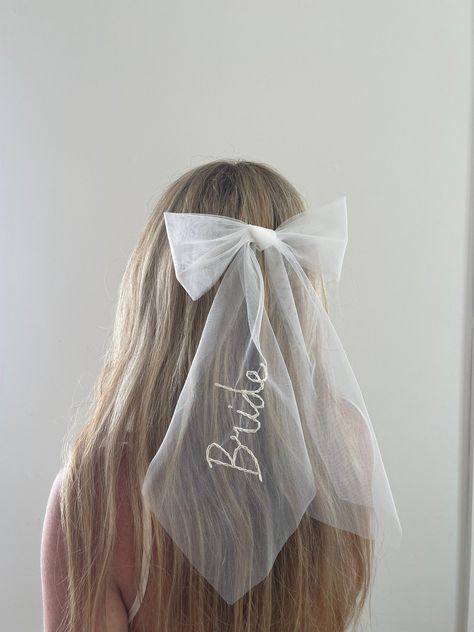 FREE DELIVERY WORLDWIDE! Look at this cute personalised veil wedding hair bow in ivory. Each Tulle Bow is hand made in my studio out of veil offcuts so they are ZERO WASTE! Which makes this the perfect bow bachelorette hair accessory for your wedding celebrations or After Party. The perfect gift either to yourself or your bride to be. Each Bridal Bow is stitched with your choice of custom word 'Bride' or 'Mrs' or 2x 'intertwined love hearts' with custom initials inside each heart & in the colour Bride Bow Hair, Bride To Be Accessories, Wedding Hair With Bow, Personalised Veil, Bow Bachelorette, Wedding Hair Bow, Bachelorette Hair, Veil Bow, Bride To Be Party