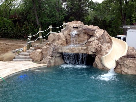 This is a custom faux rock grotto built using RicoRock faux rock products. The slide is from Dolphin Waterslides.  Credit: Grotto application by Jeff at Aquafx, NY. Backyard Pool Grotto Rock Waterfall, Pool Grotto With Slide, Pool Rock Slide, Pool Waterslide, Water Slides Backyard, Pool Design Plans, Grotto Pool, Stock Tank Pool Diy, Faux Rock