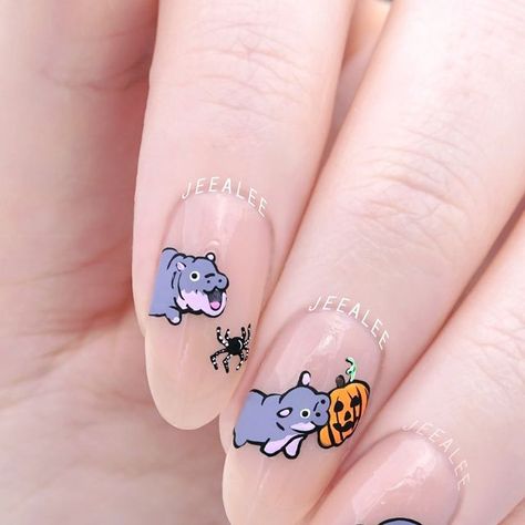 Stephanie - Nail Artist & Luxe Nail Polish Maker on Instagram: "Boo Deng!! She’s screaming at the spiders for me! 

Moo Deng is ready for Halloween! Biting on pumpkins is probably not as fun as biting on knees, though :3

..

Peach jelly nail polish is three coats of “Slip” from JL Lacquer

.
.
.

#freehandnailart #nailart #handpaintednailart hand painted Halloween Moo Deng baby hippo and ghost spooky season nail art design #moodeng" Axolotl Nail Designs, Cute Ghost Nail Art, Hippo Nails, Cute Animal Nail Art, Thailand Nails, Jelly Nail Polish, Hand Painted Halloween, Peach Jelly, Jelly Nail