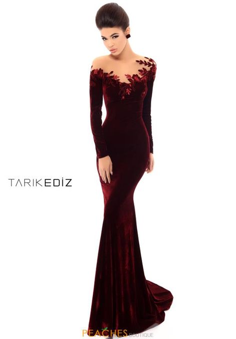 Show stopping Tarik Ediz dress 93663 is sure to turn heads when you wear it to your next black tie affair. This stunning gown features an illusion neckline adorned with floral appliques that seem to wrap organically around the neckline. This long sleeve dress is made from a luxurious velvet material that accentuates your waist and hips, hugging your body in all the right places. Ending in an elegant train, this dress is one that will be remembered long after your event is over. Black Evening Gown Classy, Feminine Contour, Tarik Ediz Dresses, Black Evening Gown, Tarik Ediz, Stunning Gowns, Grad Dresses, Groom Dress, Long Gown