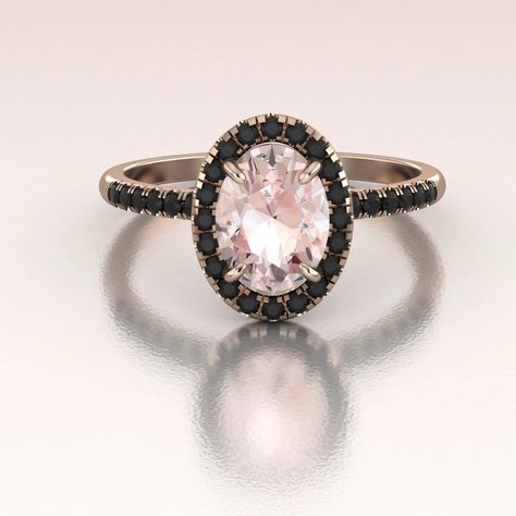 This gorgeous Morganite ring is made in 14K Rose Gold. The ring has a classic look with a contrasting color combination of soft pink and strong black tones. It can be paired with any plain or diamond band. The center stone is an oval 8x6mm surrounded by genuine Black Diamonds in a delicate halo. There are diamonds on the shank as well all set in a perfect U-set. Total diamond weight is approximately 0.25ct. Center Stone 8x6mm Oval Peach/Pink Morganite, approximately 1.60ct.We only work with envi Engagement Ring With Black Diamonds, Black Halo Engagement Ring, Black Diamond Engagement Ring Rose Gold, Rose Gold Black Stone Engagement Ring, Rose Gold Ring Black Diamond, Black Band Engagement Ring, Engagement Rings Black Diamond Rose Gold, Morganite And Black Diamond Ring, Black Stone Engagement Ring