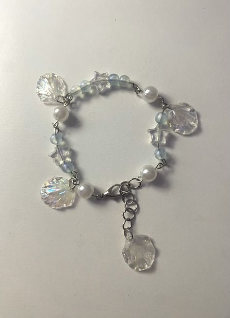 white pearl and blue translucent bead bracelet with transparent stars and dangling seashell charms Ocean Charm Bracelet, Ocean Jewelry Aesthetic, Siren Bracelet, Ocean Theme Jewelry, Diy Jellyfish, Pearl Aesthetic, Ocean Bracelet, Mermaid Core, Bracelets Ideas