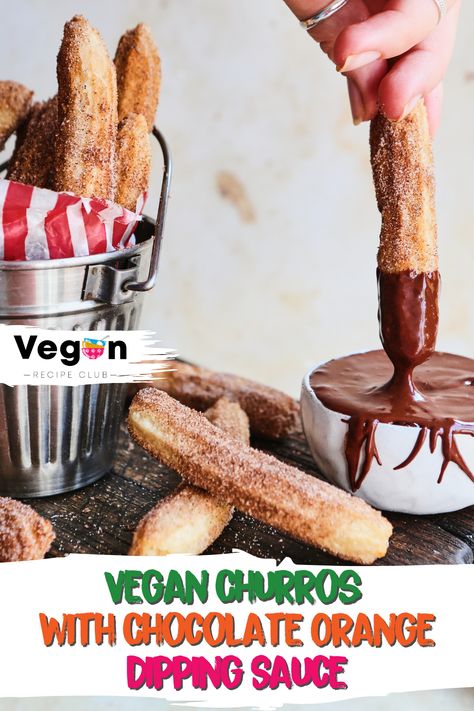 hand dipping a vegan churro into a pot with chocolate orange dip, more churros scattered around a brown wooden board and in a metal container on the right hand side. Orange Dipping Sauce, Vegan Churros, Mexican Cookies Recipes, Baked Churros, Pistachio Muffins, Earth Food, Mexican Cookies, Coconut Caramel, Vegan Dessert