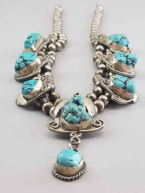 Vintage Navajo  Sterling Silver Blossom NecklaceVery unique necklace with fantastic Sleeping Beauty nugget turquoise from Globe, ArizonaThe mine was founded in 1875 and was first mined for copper and gold. Today, it’s famous for its production of Sleeping Beauty Turquoise which is known for its robin’s egg blue color, exceptional hardness, and lack of inclusions or fractures.Turquoise production at the mine closed down in August 2012 when the owners decided to focus solely on copper mining for t Squash Blossom Jewelry, Real Turquoise Jewelry, Vintage Turquoise Jewelry, Turquoise Jewelry Native American, Real Turquoise, Squash Blossom, Native Jewelry, Sleeping Beauty Turquoise, Vintage Navajo