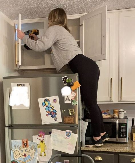 You know those cabinets over your fridge? You know, the ones you can't reach so you just store random stuff in there and forget about it. Or you just keep them empty. Yeah, you know the ones. These: There has been absolutely nothing in these cabinets since we bought this house 2 years ago. SOOOO- Let's take it down, shall we? Step 1: Remove cabinet doors Go ahead and take those useless doors off. We wont be needing them. Step 2: Remove screws Remove all screws that are attaching th… Removing Cabinets From Wall, Taking Doors Off Kitchen Cabinets, Doors Off Kitchen Cabinets, Over Fridge Ideas, Open Shelf Above Fridge, Removing Kitchen Cabinet Doors, Shelves Above Fridge, Cabinets Above Refrigerator, Cabinet Above Refrigerator