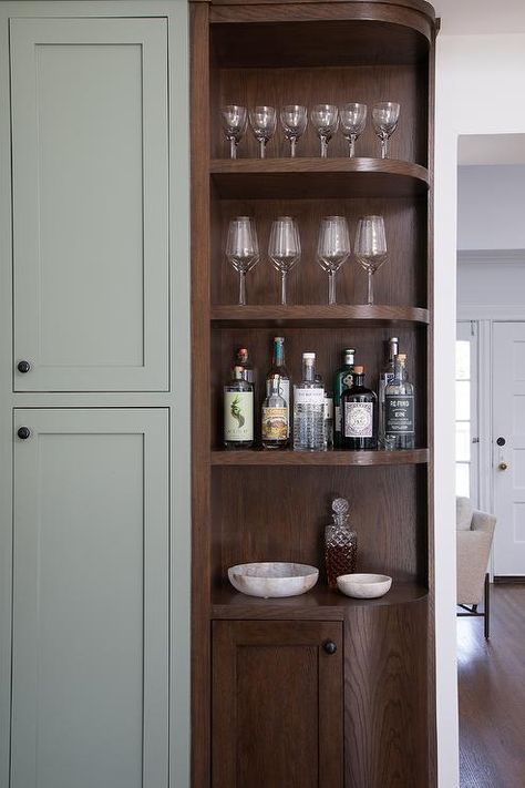 Corner rounded bar cabinet features built in shelving. Corner Built In Shelves, Kitchen Corner Shelves, Corner Built In, Gray Tile Backsplash, Pull Out Spice Rack, Corner Cabinets, Newly Remodeled Kitchens, Grey Backsplash, White Quartz Countertop