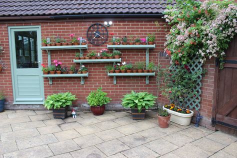 amazing Garden Shelves  #Decoration #Garden #shelf #shelves #Wall A rejuvenated garage wall with some wall shelves for my plants.   ... Garden Wall Shelves, Wall Shelves For Plants, Vertical Landscaping, Shelves On Wall, Shelves For Plants, Brick Wall Gardens, Shelves Decoration, Garden Shelf, Diy Gutters