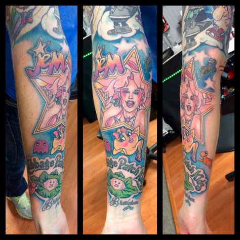 80's themed tattoo Jem, cabbage patch kids, ms pac-man 90s Baby Tattoo, 80s Tattoo Ideas, 80s Tattoo, Mr Cartoon Tattoo, Disney Sleeve Tattoos, Bright Tattoos, Cartoon Tattoo, Cartoon Character Tattoos, Famous Tattoos