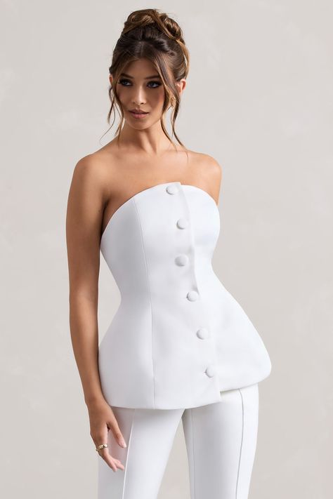 Whatever you decide to pair it with, Century is a stand-out staple. Arriving in a soft cream shade of our signature satin, this structured piece cinches your waist through self covered buttons that flow down its front.Features - Premium satin- Structured fit - Curved bandeau neckline- Self-covered buttons- Zip closure - Ruffled hemline - Corset designSizing & Fit Model is 5'7 and wears UK size 8 / US size 4Product Information Designed exclusively by Club L London Lined with no stretch Premium sa Clothing Line Branding, Corset Designs Ideas, Built Up Neckline, Corset Neckline, Elegant Corset, Satin Clothes, Top Neckline, Curved Neckline, Corset Design