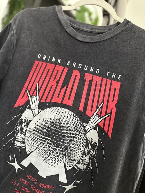 Drink Around The World - World Tour Vintage Black Tee! Featuring a vintage black rock tee design, this shirt showcases the iconic Epcot ball and highlights all the countries where you can indulge in delicious drinks. Get ready for a global adventure! Band Tour Tshirt Design, Tour Merch Design, Tour Tshirt Design, Epcot Ball, Svt Concert, Vintage Rock Shirt, Marathon Tee, Graphic Tees Street Style, Vintage Rock T Shirts