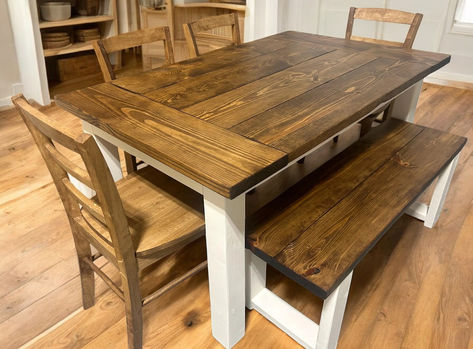 A cozy, farmhouse-style dining room featuring a distressed white 5ft wooden dining table, surrounded by rustic decor. Farmhouse Table With Bench Seating, Wooden Farmhouse Table, Minwax Provincial, Breadboard Ends, Distressed Decor, Farmhouse Tables, Wooden Farmhouse, Chair Options, Classic Farmhouse