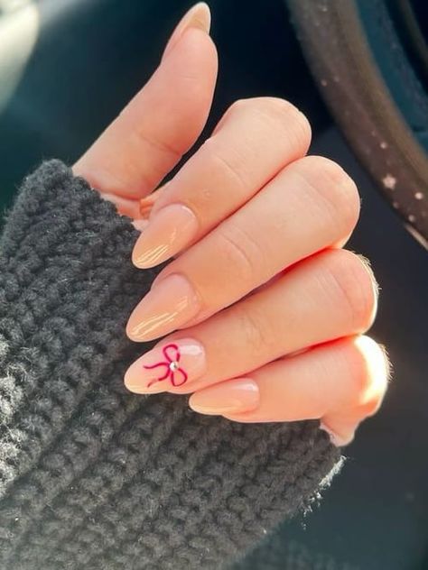 Nude Nails with Red Bow Light Pink Nails With Red Bow, Nude Nails With Red Bow, Oxblood And Gold Nails, Nude Nails With Red Design, Neutral Bow Nails, Christmas Minimal Nails, Nails With Red Bow, Christmas Bow Nails Design, Red Nails With Bows