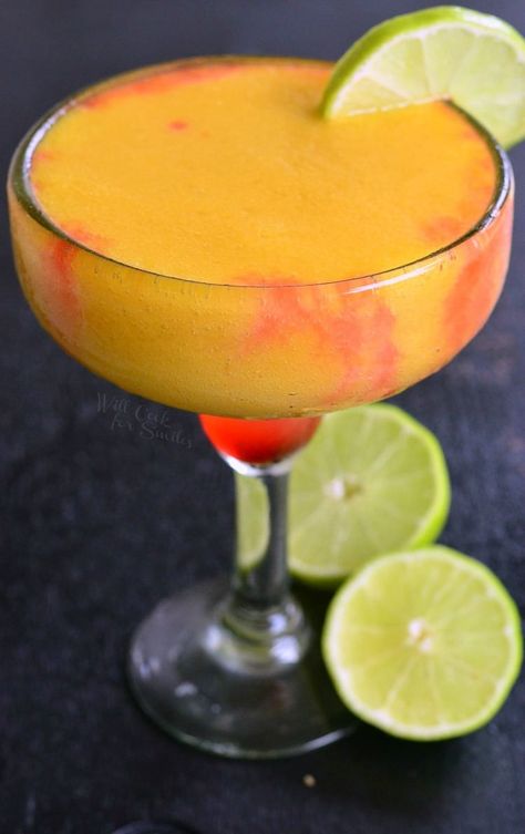 Sunset Margarita that is orange and a red in a margarita glass with a lime as a garnish Creative Margarita Recipes, Pineapple Margarita Recipe, Frozen Mango Margarita, Will Cook For Smiles, Frozen Margarita, Pineapple Margarita, Frozen Drink, Mango Pineapple, Mango Margarita