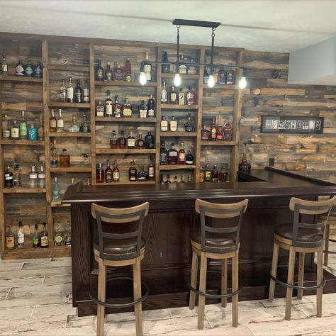 Home bar with bourbon display shelves using reclaimed barn wood Bourbon Room Ideas Rustic, Whiskey Decanter Display Ideas, Basement Bourbon Bar Ideas, Basement Bar Shelving Ideas, Bourbon Wall Display, Whiskey Bar Home, Bourbon Shelf Ideas, Home Bourbon Bar, Bourbon Display Ideas