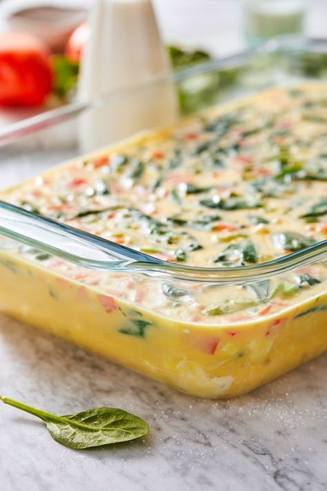 This easy Breakfast Casserole recipe is made with eggs, spinach, tomatoes and Feta cheese and only takes a few minutes to whip up. You can make it ahead of time, so it’s the perfect breakfast egg casserole for Christmas morning or any day! #breakfastcasserole Breakfast Casserole With Spinach, Casserole With Spinach, Tomatoes And Feta Cheese, Eggs Spinach, Christmas Breakfast Casserole, Easy Breakfast Casserole, Tomatoes And Feta, Easy Breakfast Casserole Recipes, Spinach Breakfast