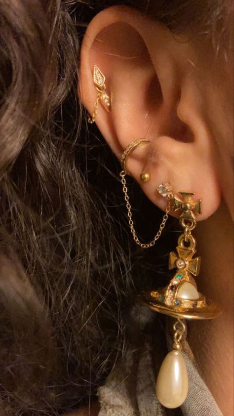 Ear Piercing Multiple Ear Piercings Aesthetic Classy, Vivienne Westwood Earring Stack, Maximilist Jewelery, Maximalist Piercings, Maximalist Earring Stack, Decorated Ear Piercings, Maximalist Ear Piercings, Ese Piercings, Hippie Ear Piercings