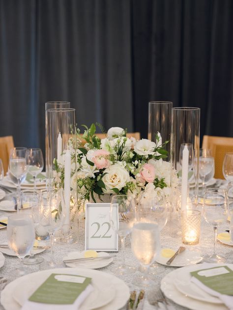 A beautiful sage green wedding tablescape with glass candles and green and white florals | wedding table decor, wedding tablescape inspiration, sage wedding decor, candlelit reception tables Sage Green Wedding Reception Table, Sage And Pearl Wedding, Sage Wedding Tablescape, Sage Green Table Setting, Green Wedding Tablescape, Sage Wedding Decor, White Florals Wedding, Green And White Florals, Green Table Settings