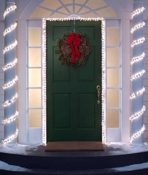 Wrap white lights around your pillars and doorframe - ELLEDecor.com Porch Xmas Lights, Exterior Christmas Decorations, Porch Decoration Ideas, House Pillars, Porch Pillars, Christmas Front Porch Ideas, Cow Skull Decor, Front Porch Lighting, Urban Decor