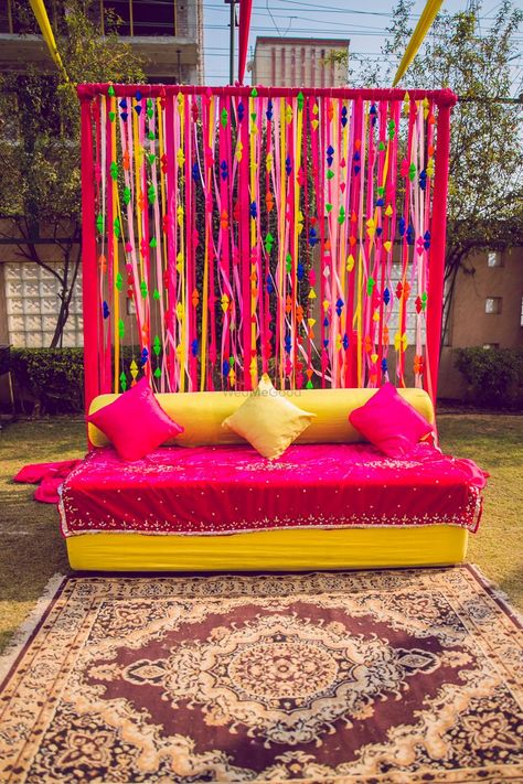 Photo of Colourful haldi decor with a bright pink theme. Rakshabandhan Decoration Ideas At Home, Holi Decorations Ideas At Home, Holi Theme Decoration At Home, Mehndi Backdrop, Interesting Backgrounds, Haldi Ceremony Decorations, Haldi Decoration, Mehndi Function, Mehendi Decor Ideas