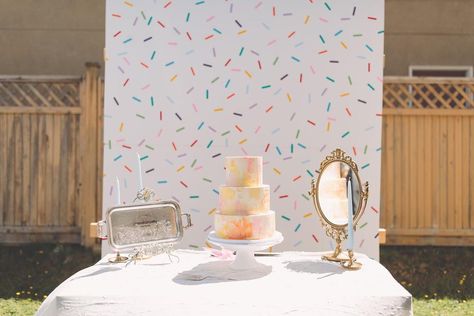 Interested in creating your own wedding photo booth? Learn how to make this fun sprinkle backdrop! Sprinkle Photo Backdrop, Sprinkle Backdrop, Baby Shower Reveal Ideas, Diy Wedding Photo Booth, Wedding Ceremony Songs, Baby Girl Sprinkle, Diy Sprinkles, Photography Backdrops Diy, Baby Birthday Party Theme