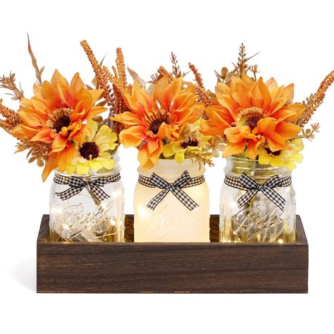 PRICES MAY VARY. 【Fall Decor Mason Jar Set】Package includes 3 harvest fall decorated Mason jars, 3 beautiful faux artificial bouquets and 1 rustic wooden tray. Multiple colors of farmhouse Mason jars can give you more decorating inspiration, and multiple sets can be combined to give you more flexibility to match your farmhouse table decor. 【Fall Centerpiece Table Decorations】Colorful decorative jars paired with vibrant artificial flower bouquets are the perfect fall table centerpiece to add vibr Farmhouse Fall Table Decor, Fall Mason Jar Centerpieces, Centerpiece For Table, Dinner Table Centerpieces, Thanksgiving Home Decor, Mason Jar Centerpiece, Fall Mason Jars, Kitchen Table Centerpiece, Farmhouse Table Decor