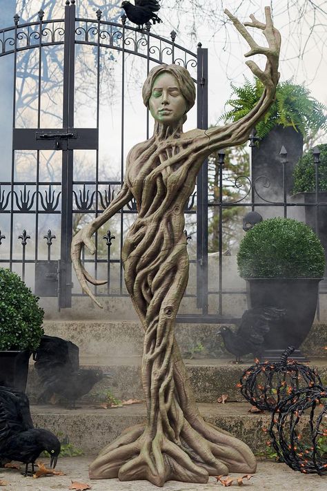 This haunting life-sized figure has a gnarled body made of tree roots, tree branch arms, and a creepy woman's head with closed eyes that you pray never open. Chicken Wire Ghost, Tree Branch Crafts, Haunted Tree, Halloween Ghost Decorations, Tree Statues, Haunted Forest, Tree Root, Creepy Halloween Decorations, Life Size Statues