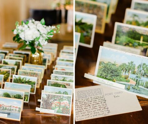 Old Florida Inspired Wedding Reception Escort Card Table with Vintage Postcards and Small White Floral with Greenery in Gold Vase | Tampa Bay Wedding Planner Glitz Events Card Station Wedding, Postcard Place Cards, Small Seating Chart Wedding, Postcard Place Cards Wedding, Postcard Wedding Favors, Florida Wedding Invitations, Postcard Wedding Table Numbers, Small Wedding Inspiration, Vintage Postcards Wedding Decor