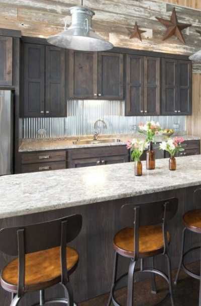 23 Tin Backsplash Design Ideas for Your Kitchen | Sebring Design Build Corrugated Tin Backsplash Kitchen, Tin In Kitchen, Corrugated Backsplash Kitchen, Tin On Walls Ideas Kitchen, Sheet Metal Backsplash Kitchen, Corrugated Metal Wall Kitchen, Galvanized Backsplash Kitchen, Log Cabin Kitchen Backsplash Ideas, Log Cabin Kitchen Backsplash