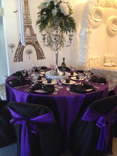 Black & Purple guest table display Dark Purple Table Setting, Black Silver And Purple Party, Purple Masquerade Quinceanera Ideas, Purple And Black Quinceanera Ideas, Black Purple And Silver Table Setting, Black And Purple Table Setting, Royal Purple Quinceanera Theme, Black Purple Silver Party, Purple Black And Silver Party Ideas