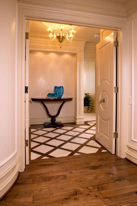 The vestibule of this penthouse is defined by a dramatic basket weave pattern created by American walnut planks inlaid with stone. The wide walnut planks provide a beautiful transition into the home’s master suite. Stone And Wood Flooring Transition, Tile With Wood Inlay, Breakfast Sunroom, Bedroom Floor Tiles, Tile Inlay, Foyer Flooring, Tiles Designs, Entryway Flooring, Luxe Bedroom