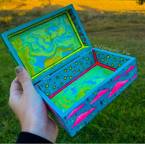 A psychedelic inspired stash box with a Paint pour pattern & Neon detailing ✨ Follow me at @HypnoticEyeArt for more! #painted #acrylicpouring #trippy #art Diy Stash Box Painting Ideas, Stash Box Painting Ideas Trippy, Trippy Box Painting Ideas, Stash Box Painting Ideas, Box Painting Ideas, Wooden Box Diy, Box Painting, Hand Painted Wooden Box, Whimsical Painted Furniture