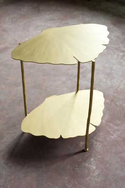 vanCollier Susanne Tiered Ginkgo Table Crafted out of steel and hand-painted with a gilded finish, this organically-shaped side table from the Ginkgo Collection is inspired by the leaves of the tree. A broad fan-shaped leaf serves as the top and bottom of the table with three hammered steel legs. Measures approximately 22″ wide x 16″deep x 24″ tall. Custom finishes available. #HPmkt Ginkgo Design, Tiered Table, Ginkgo Leaves, Cute Diy Room Decor, Ginkgo Biloba, Curved Sofa, Ginkgo Leaf, Funky Furniture, Metal Furniture