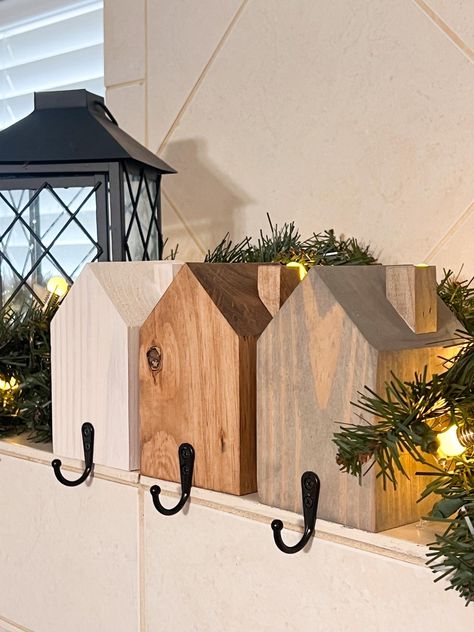 Rustic Holiday Charm in Every Home! Add a cozy, farmhouse touch to your Christmas mantle with these adorable Rustic House Stocking Holders! Each piece is lovingly handcrafted from solid wood, designed to look like a charming little house, perfect for hanging your stockings this holiday season. Whether you're going for a minimal, rustic, or farmhouse-inspired look, these stocking holders add a unique twist to your holiday decor. Handcrafted with Love: We build each house stocking holder by hand. Wooden Christmas Decorations For Outside, Wood Projects For Holidays, Diy Wood Holiday Projects, Wooden Home Projects, Wooden Stocking Hangers, Barnwood Christmas Decor, Wood Project For Christmas, Simple Wooden Crafts To Sell, Simple Christmas Wood Projects