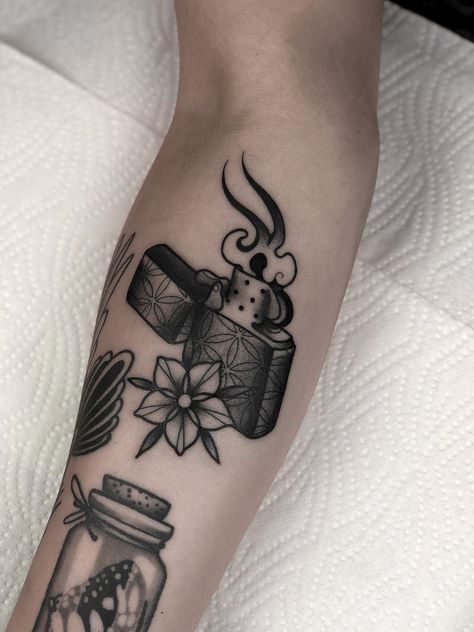 Black and grey lighter tattoo by Marco Gruschwitz Lighter Tattoo Traditional, Traditional Lighter Tattoo, Neo Traditional Tattoos Black And Grey, Neotraditional Tattoo Black And Grey, Black And Grey American Traditional, Zippo Lighter Tattoo, Zippo Tattoo, Lighter Tattoo, Traditional Tattoo Black And Grey